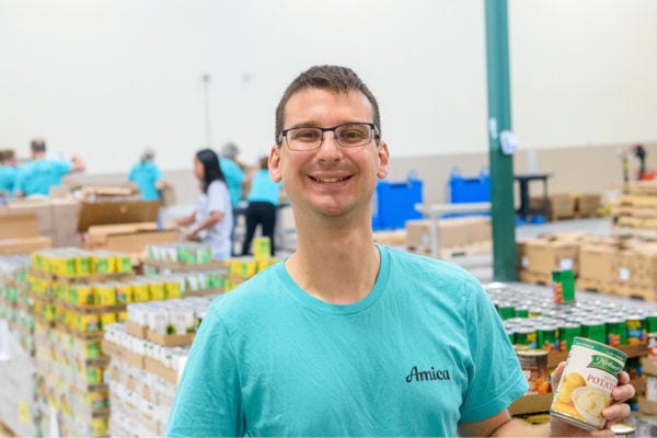 Amica employee volunteering at a community event.