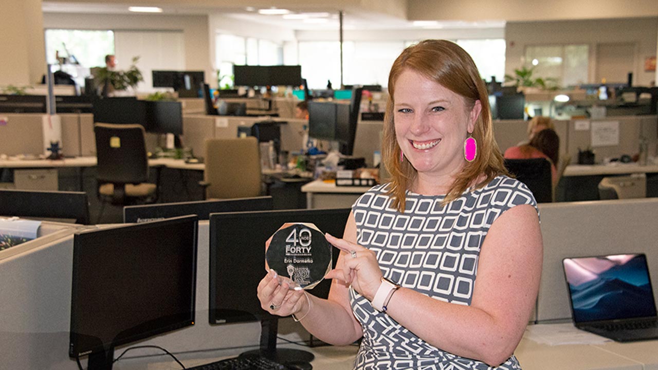 Erin Darmetko holding trophy: recipient of Providence Business News' '40 Under Forty'