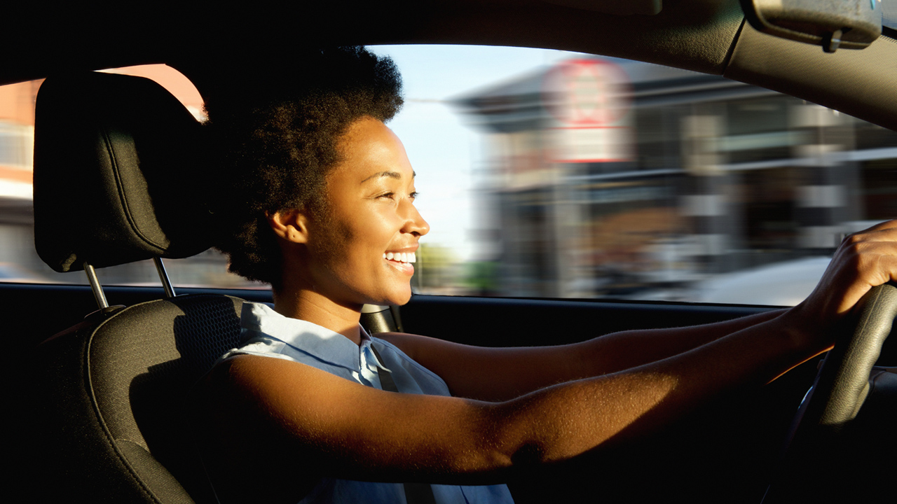 Smiling Woman Driving Car