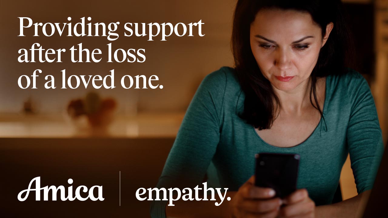 Woman looking at her phone. The image reads "Providing support after the loss of a loved one."