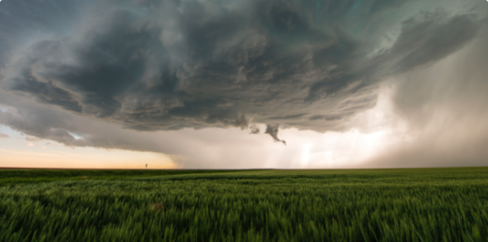 Tornado about to touch down in an empty field