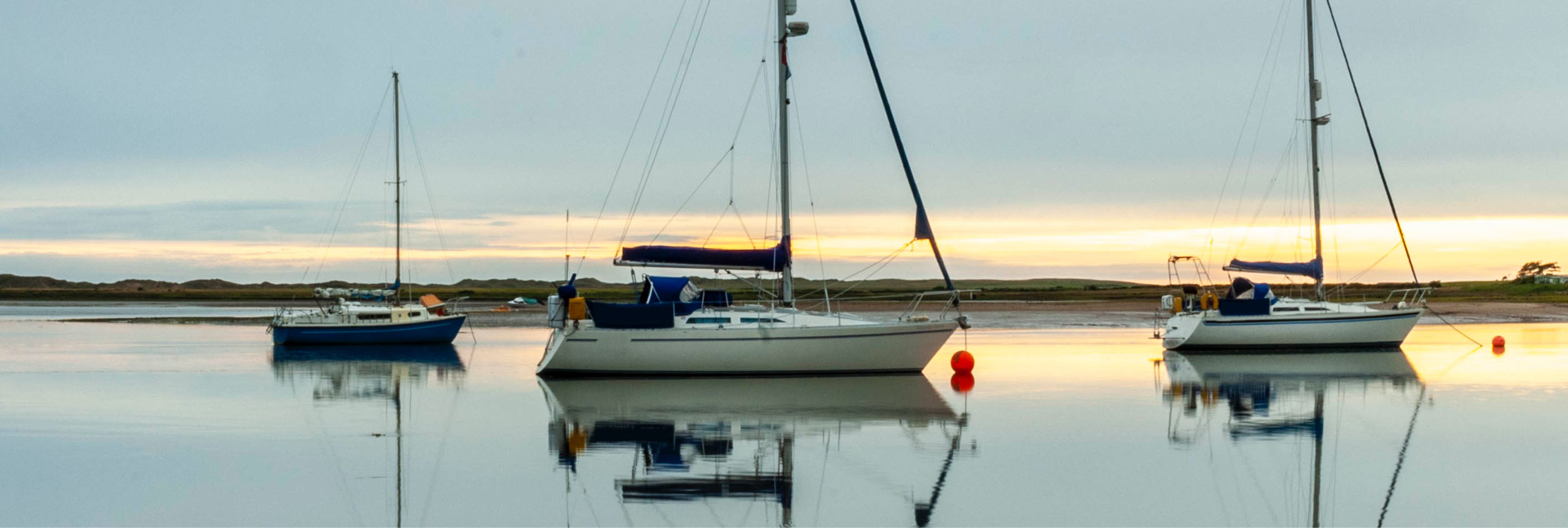 Boat sailing on the ocean into the sunset